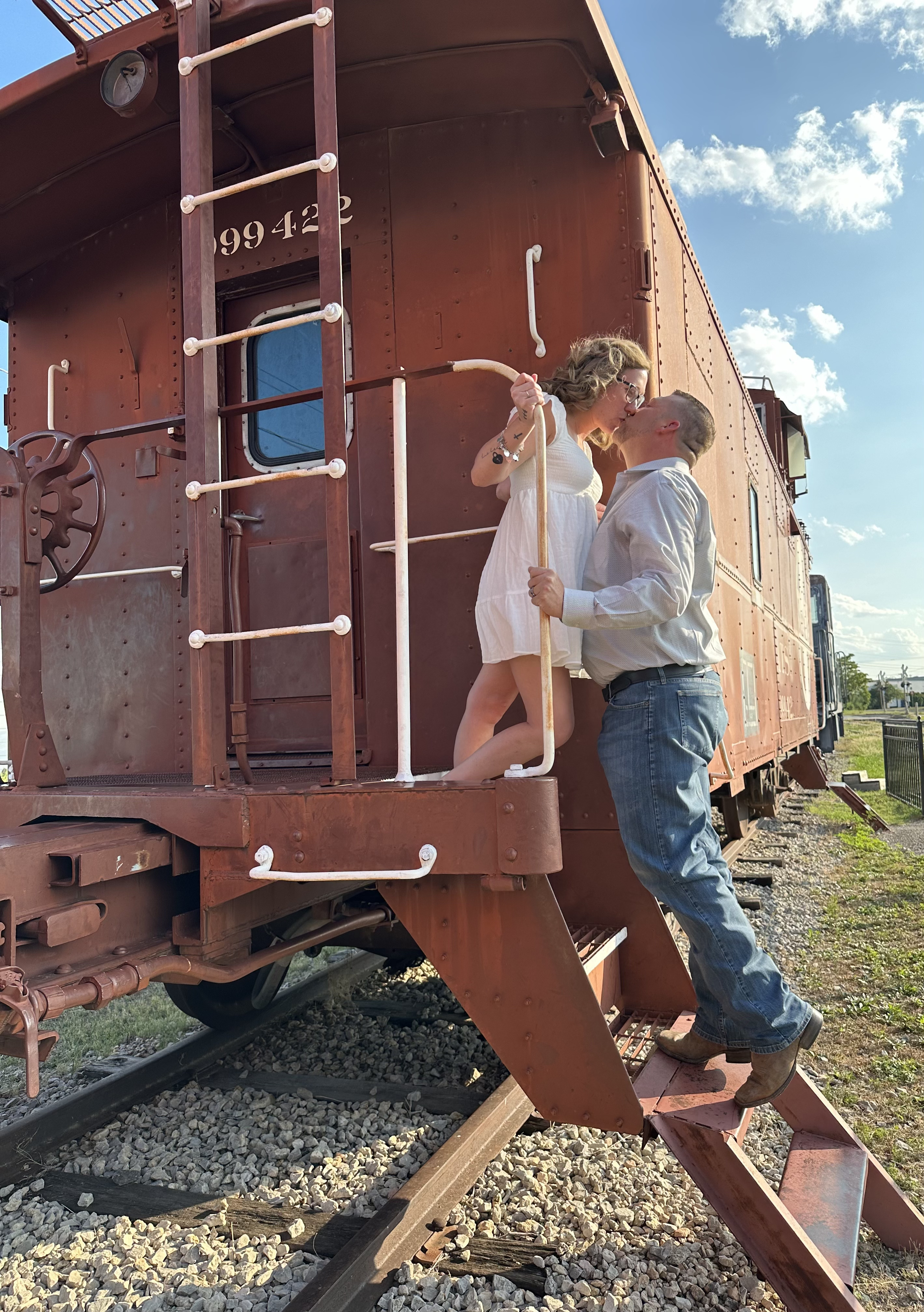 Devon and Lindy beside a vintage train car.